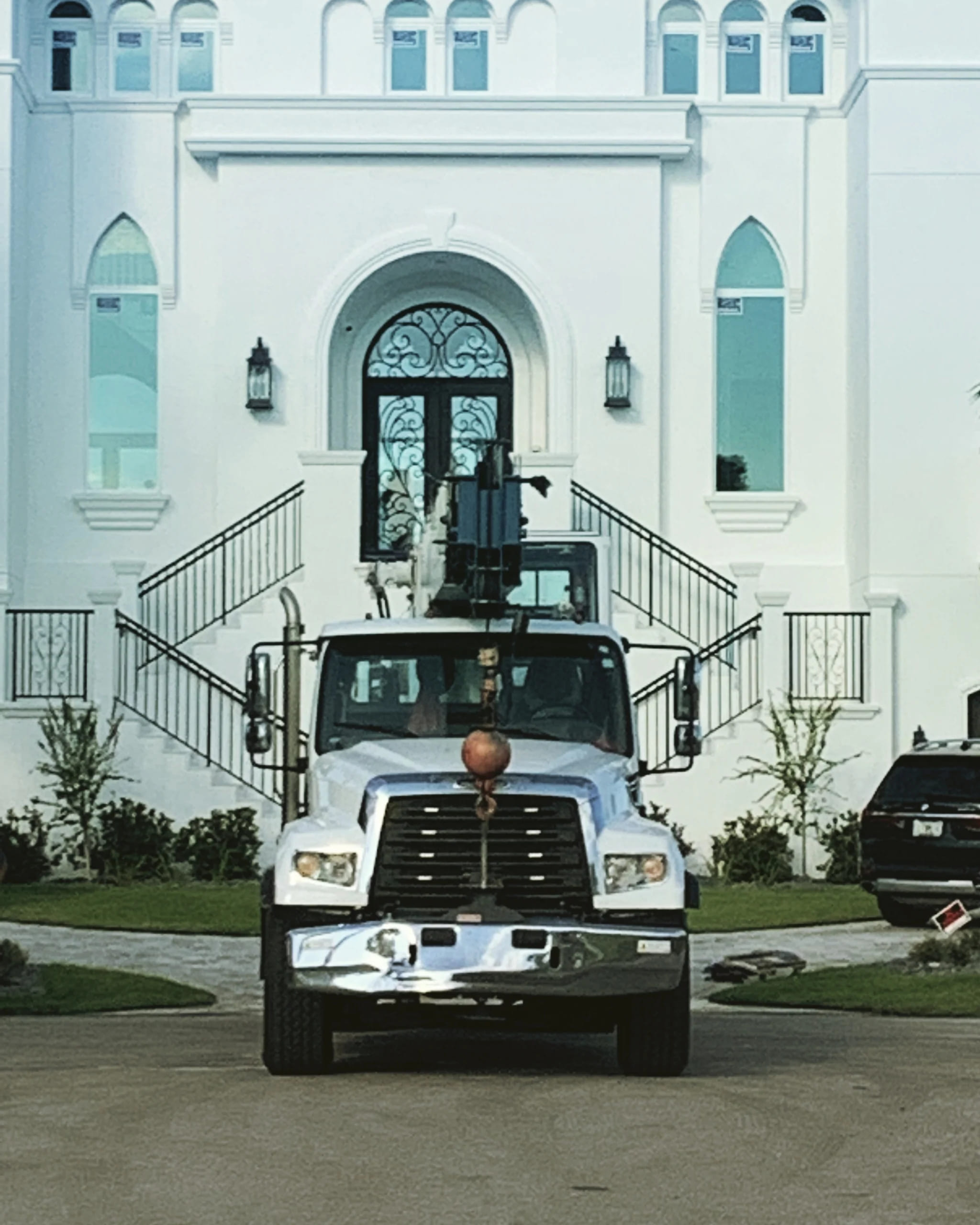 White moving van parked outside building
