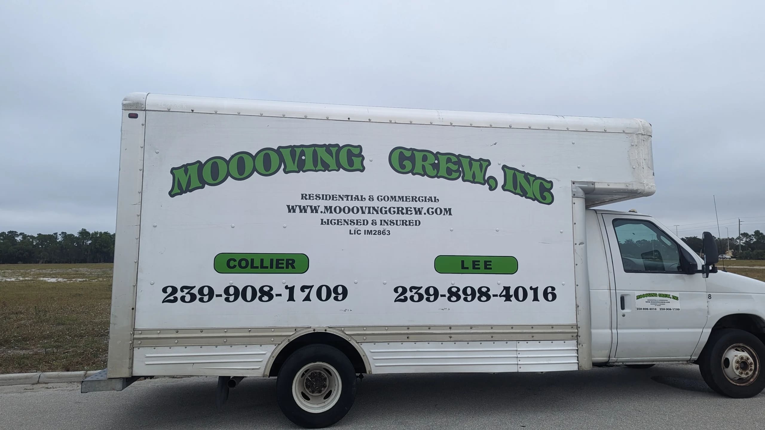 MOOOVING CREW moving trucks parked in lot